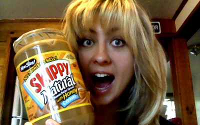 Woman Showing Jar of Peanut Butter