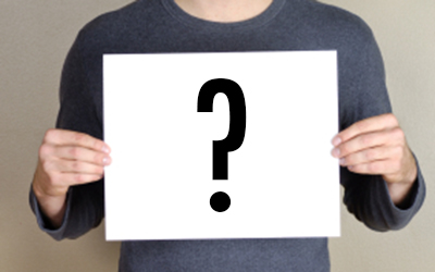 Student Holding Sign With Question Mark