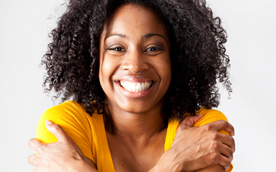 Smiling Female Student Hugging Herself